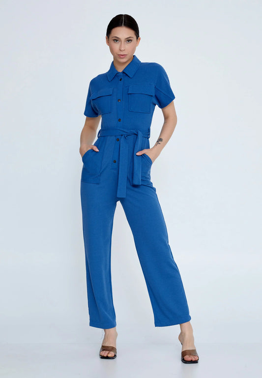 Woman wearing a blue jumpsuit on a white background